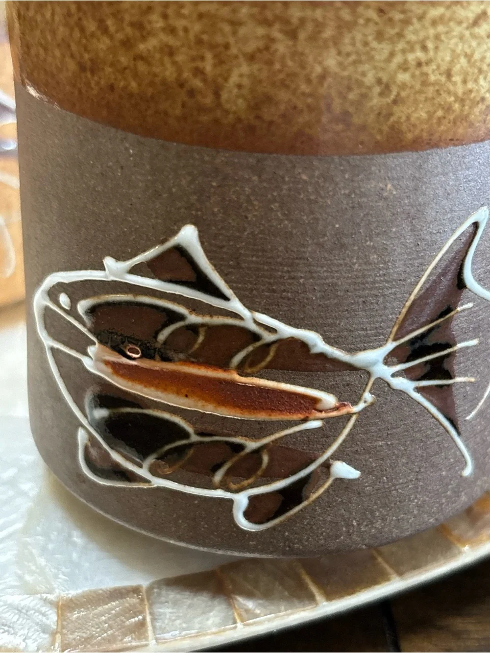 Three vintage stoneware pottery mugs with hand painted fish